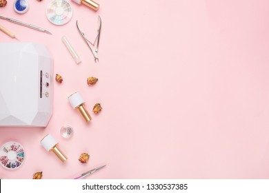 Beauty Accessories For Manicure And Pedicure On A Pink Background,. Samples Of Nail Polish, Scissors, Manicure Ultraviolet Machine, Nippers And Other Accessories For Home And Salon Procedures