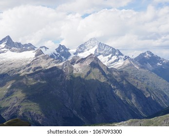 Beauty alpine mountains range landscapes in swiss Alps at SWITZERLAND, picturesque rocky scenery seen from Gornergrat near Zermatt village, cloudy blue sky in 2017 warm sunny summer day Europe on July - Shutterstock ID 1067093300