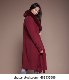 Beauty Asian Fashion Model Girl In Fur Coat. Beautiful Luxury Winter Woman On Beige Background.