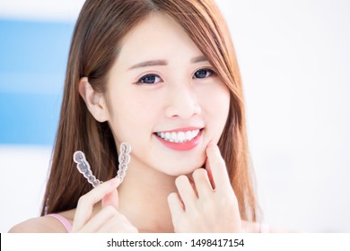 Beauty Asian Girl Hold Invisible Braces With Beautiful Teeth