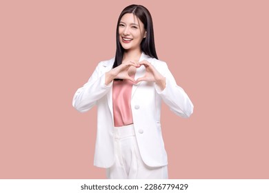 Beauty Asian woman making heart shape hand sign isolated on pink background. - Powered by Shutterstock