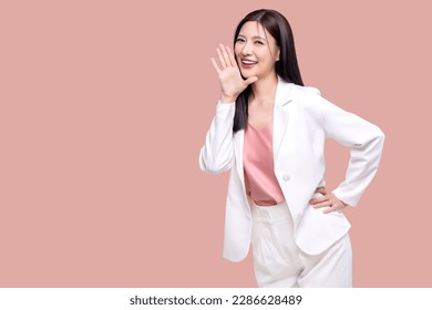 Beauty Asian woman with open mouths raising hands shouting good news isolated on pink background.