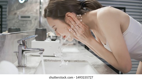 Beauty Asian Woman Wash Her Face At Night