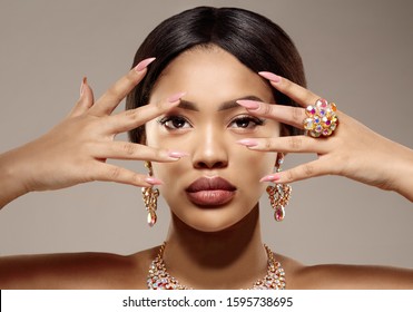 Beauty Black Skin Woman African Ethnic Female Face. Luxury Young African American Model With Jewelry, Earrings And Ring
