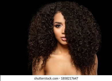 Beauty black skin woman African Ethnic female face. Young african american model with long afro hair. Lux model on black.