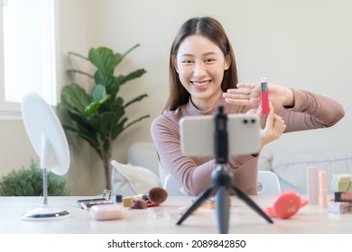 Beauty blogger, asian young woman, girl vlogger makeup face, showing, reviews cosmetics products while recording video, tutorial to share on social media. Business online influencer on smartphone. - Powered by Shutterstock