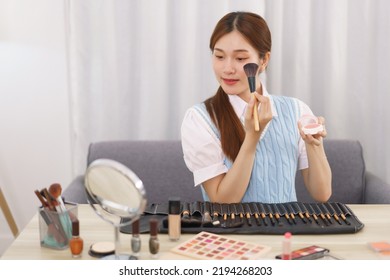 Beauty Blogger Concept, Asian Woman Apply Blush On Cheek To Review Makeup Product In Live Streaming.