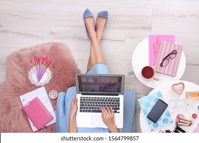 Beauty blogger with laptop and cosmetics sitting on floor, top view - Shutterstock ID 1564799857