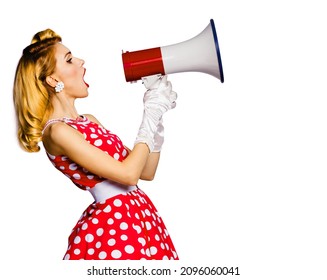 Beauty Blond Haired Woman Holding Megaphone Loudspeaker, Shout Something. Girl In Pin Up Style Red Dress In Polka Dot With Mega Phone, Isolated Over White Background. Retro Fashion Vintage Studio Shot