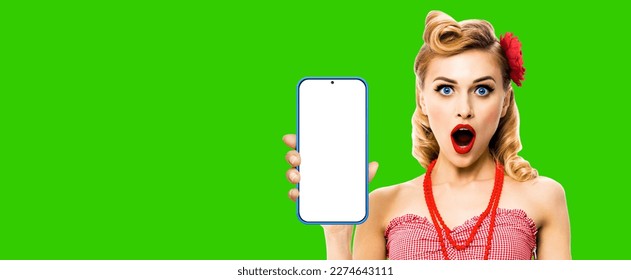 Beauty blond haired woman holding megaphone, shout something. Girl in red pin up style plaid shirt, green chroma key background. Female model in retro vintage studio concept. - Powered by Shutterstock