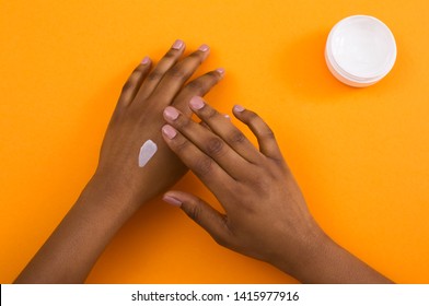 Beauty And Body Care Concept. African American Woman Applying Cosmetic Hand Cream On Soft Healthy Skin.