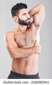 Beauty, body and underarm with a man model in studio on a gray background for health or wellness. Skin, chest and muscle with a handsome young male standing indoor to promote a health lifestyle