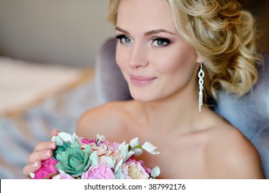 Beauty Bride In Bridal Gown With Bouquet And Lace Veil Indoors. Beautiful Model Girl In A White Wedding Dress. Female Portrait Of Cute Lady. Woman With Hairstyle