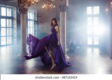 Beauty Brunette Model Woman In Evening Purple Dress. Beautiful Fashion Luxury Makeup And Hairstyle