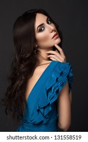 Beauty Brunette Picture. Beautiful Woman In A Blue Dress.