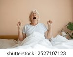 Beauty Caucasian 50s 60s woman awaking, wake up on the bed. Young beautiful female stretching her arms in fresh early morning, relax peaceful morning routine yawn concept banner