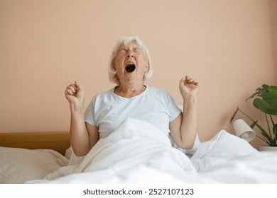 Beauty Caucasian 50s 60s woman awaking, wake up on the bed. Young beautiful female stretching her arms in fresh early morning, relax peaceful morning routine yawn concept banner - Powered by Shutterstock