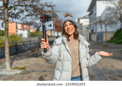 Beauty caucasian female vlogger talking to the audience recording online video at city - Powered by Shutterstock