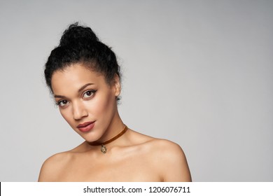 Beauty Closeup Portrait Of Beautiful Mixed Race Woman Wearing Chocker Looking At Camera, Isolated On Gray Background