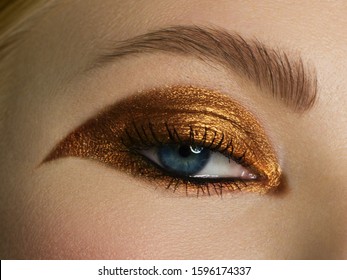 Beauty close-up portrait of beautiful young woman model face with clean skin. Wellness, skincare and bright black liner and gold make-up. extremaly long eyelashes