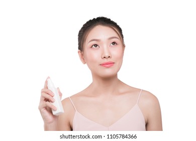 Beauty concept. Asian pretty woman with perfect skin applying spray water treatment on face