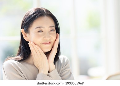 Beauty Concept Of Middle Aged Asian Woman. Skin Care. Hair Care.