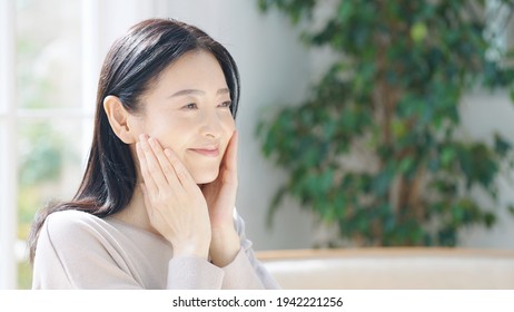 Beauty Concept Of Middle Aged Asian Woman. Skin Care. Hair Care. 