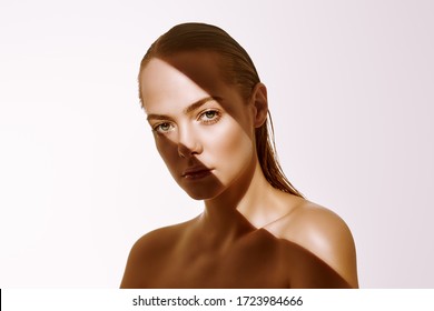 Beauty Concept. Portrait Of A Beautiful Young Woman With Fresh Natural Make-up And Perfect Healthy Skin. The Play Of Light And Shadow. Fashion. Copy Space.