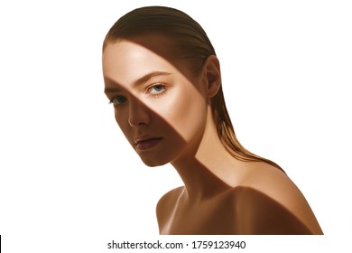 Beauty Concept. Portrait Of A Beautiful Young Woman With Fresh Natural Make-up And Perfect Healthy Skin. The Play Of Light And Shadow. Fashion. Copy Space.