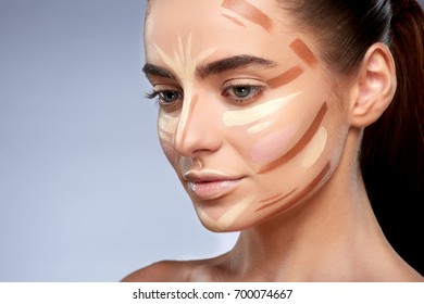 Beauty concept. Portrait of woman with contouring on face, base for make-up. Types of drawing make-up, half profile of woman with nude make-up looking down