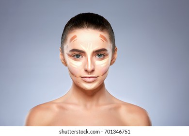 Beauty concept. Portrait of woman with contouring on face, base for make-up. Types of drawing make-up, head and shoulders of girl with nude make-up looking at camera