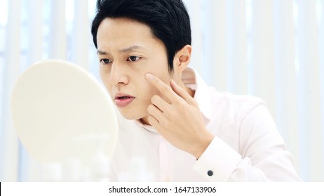 Beauty concept of a young asian man. Skin care.