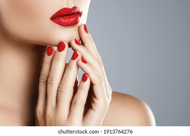 Beauty And Cosmetics. Close-up Of Female Mouth And Nails With Red Manicure And Lipstick.