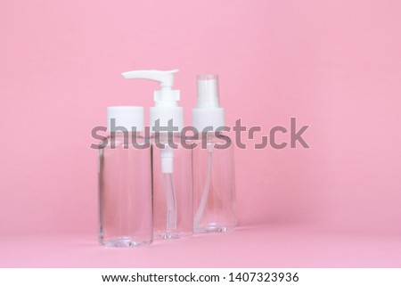 Beauty cosmetics glassbottle; branding mock up; front view on pastel pink background. Package for essential oil.