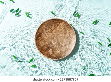 Beauty cosmetics product presentation scene made with wooden pedestal floating blue water. Top view backdrop. - Shutterstock ID 2273887959