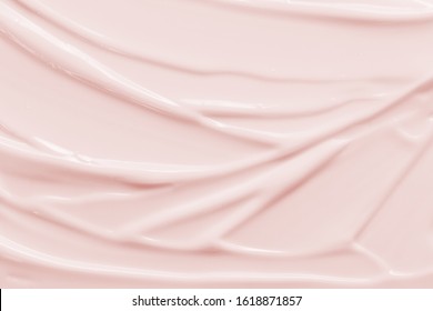 Beauty cream texture background. Pink color face cream lotion moisturizer smear. Skincare cosmetic  product  strokes