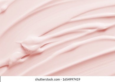 Beauty cream texture background. Pink color cosmetic cream lotion moisturizer smear. Skincare product  strokes