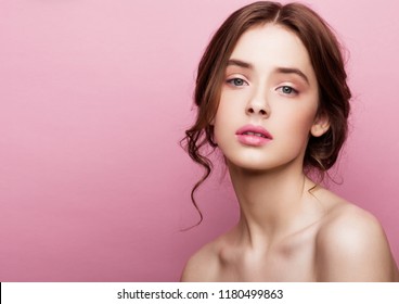 Beauty cute fashion model girl with natural make up on pink background. Beautiful woman girl with elegant hair. Natural beauty