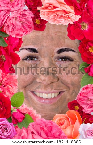 Beauty day. The woman has a clay face mask and eyebrows painted black. Her face is framed by flowers.