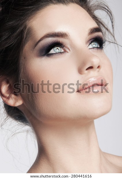 Beauty face\
makeup. Make up. Eyelashes extensions. Perfect Make-up closeup.\
Foundation. Cosmetic Eyeshadows, eyebrows. Beauty Girl with Perfect\
Skin. Eyelashes.\
Makeover