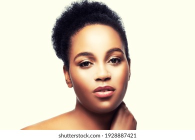 Beauty face of sensual African American woman with healthy skin, afro hairstyle and glamour makeup, isolated on light background.