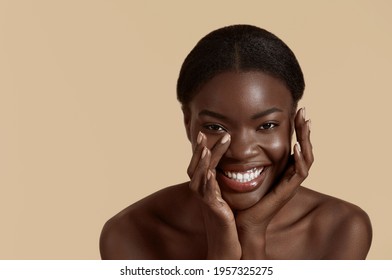 Beauty Face. Smiling Black Woman Touching Healthy Skin Portrait. Beautiful Girl With Glowing Skin And Natural Makeup`. Skin Care Concept