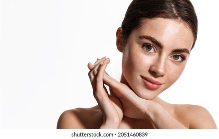 Beauty face and spa. Woman with freckles, clean nourished skin, biting lip and look aside. Girl model using antiaging cosmetics and vitamin c serum for bettet smoother skin tone, white background - Shutterstock ID 2051460839