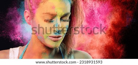 Beauty face woman covered in holi powder with a rainbow color explosion in the background. Festival of colors concept. Panorama Banner with copy space.