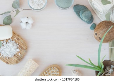 Beauty And Fashion Concept With Spa Setting. Composition With Dead Sea Salt, Coconut,  Natural Cosmetic Blue Clay,  Soda, Loofah. Flat Lay, Spa Concept With Cotton Flower, Stones And Towel.