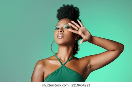 Beauty, Fashion And Empowerment With A Beautiful Black Woman In Studio Of A Green Background For Style. Makeup, Cosmetics And Trendy With An Edgy Female Model Posing For Individuality And Equality