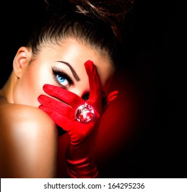 Beauty Fashion Glamorous Model Girl Portrait. Vintage Style Mysterious Woman Wearing Red Glamour Gloves. Jewellery. Jewelry. Holiday Hairstyle And Make-up. Diamond Ring. Retro Lady With Blue Eyes 