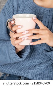 Beauty, Fashion And Lifestyle Concept. Woman With Blue Sweater Holding Big Cup Of Hot Drink. Woman With Beautiful Pink Nails French Manicure. Relaxation At Home, Positive Emotions