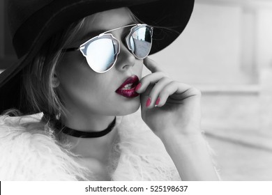Beauty Fashion model girl black and white portrait, wearing stylish sunglasses and choker. Sexy woman portrait with perfect makeup and manicure,trendy accessories and wide hat. Beauty  fashion trends
