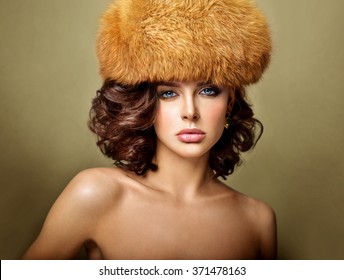 Beauty Fashion Model Girl in a Red Fox Fur Hat